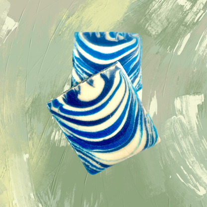 Blue and white striped soap bars on a textured green background