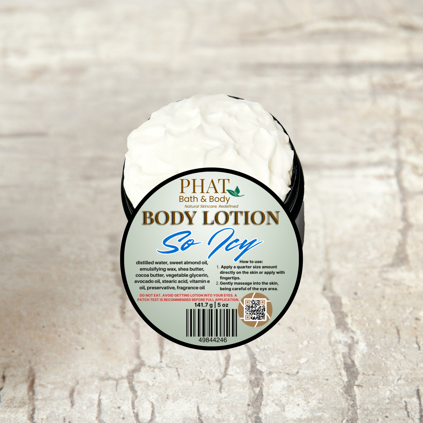 Body lotion container with 'Phat Bath & Body' label on a textured beige background