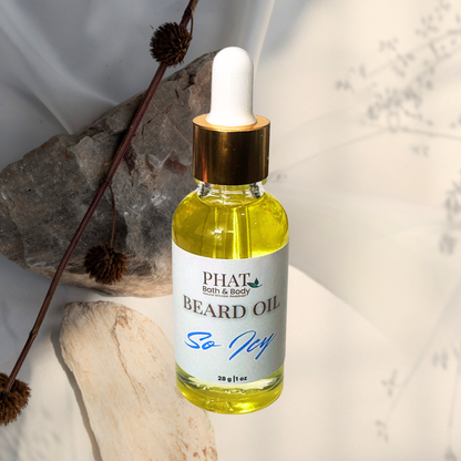 Bottle of Phat Bath & Body beard oil with a white cap on a textured surface.