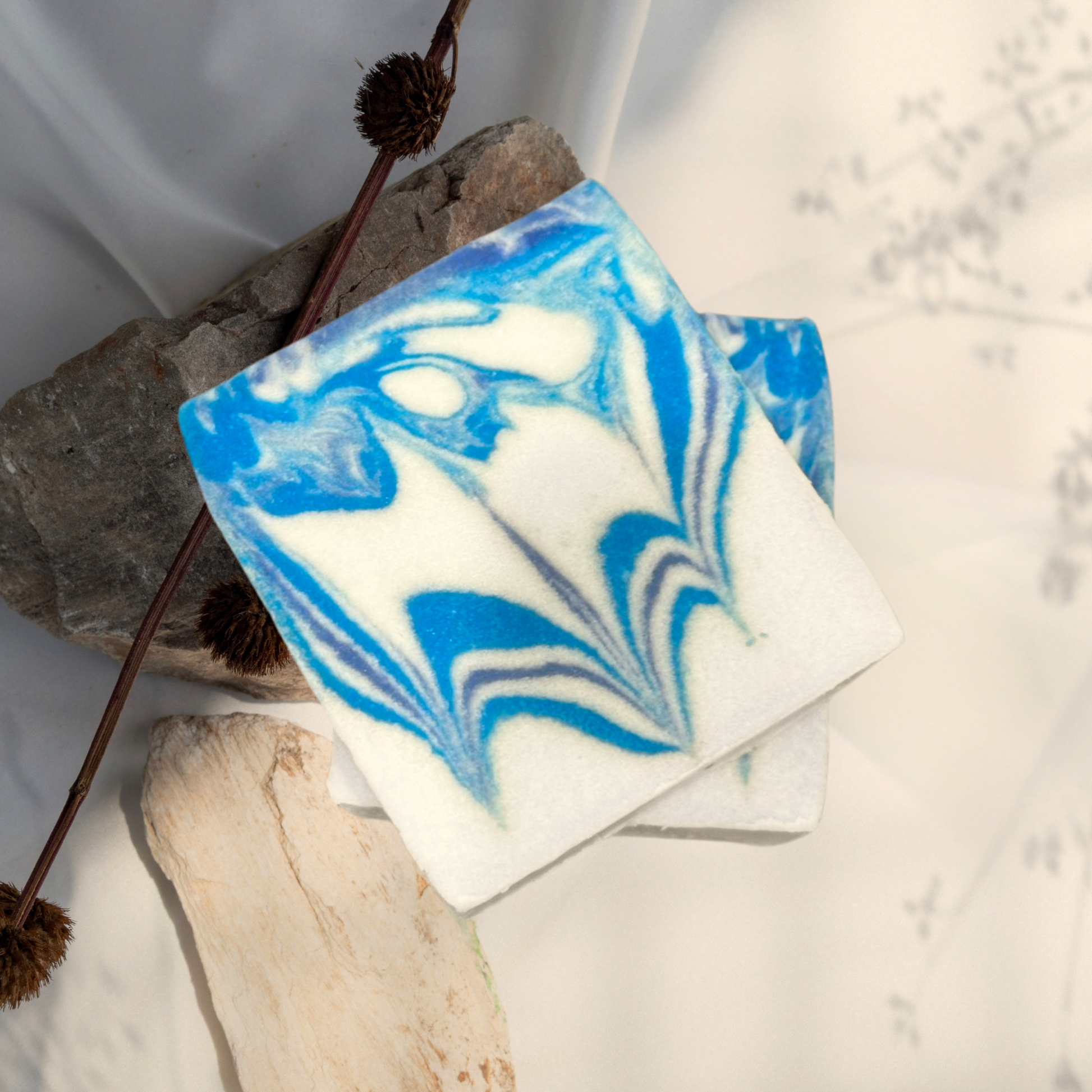 Marbled blue and white soap bar on a neutral background