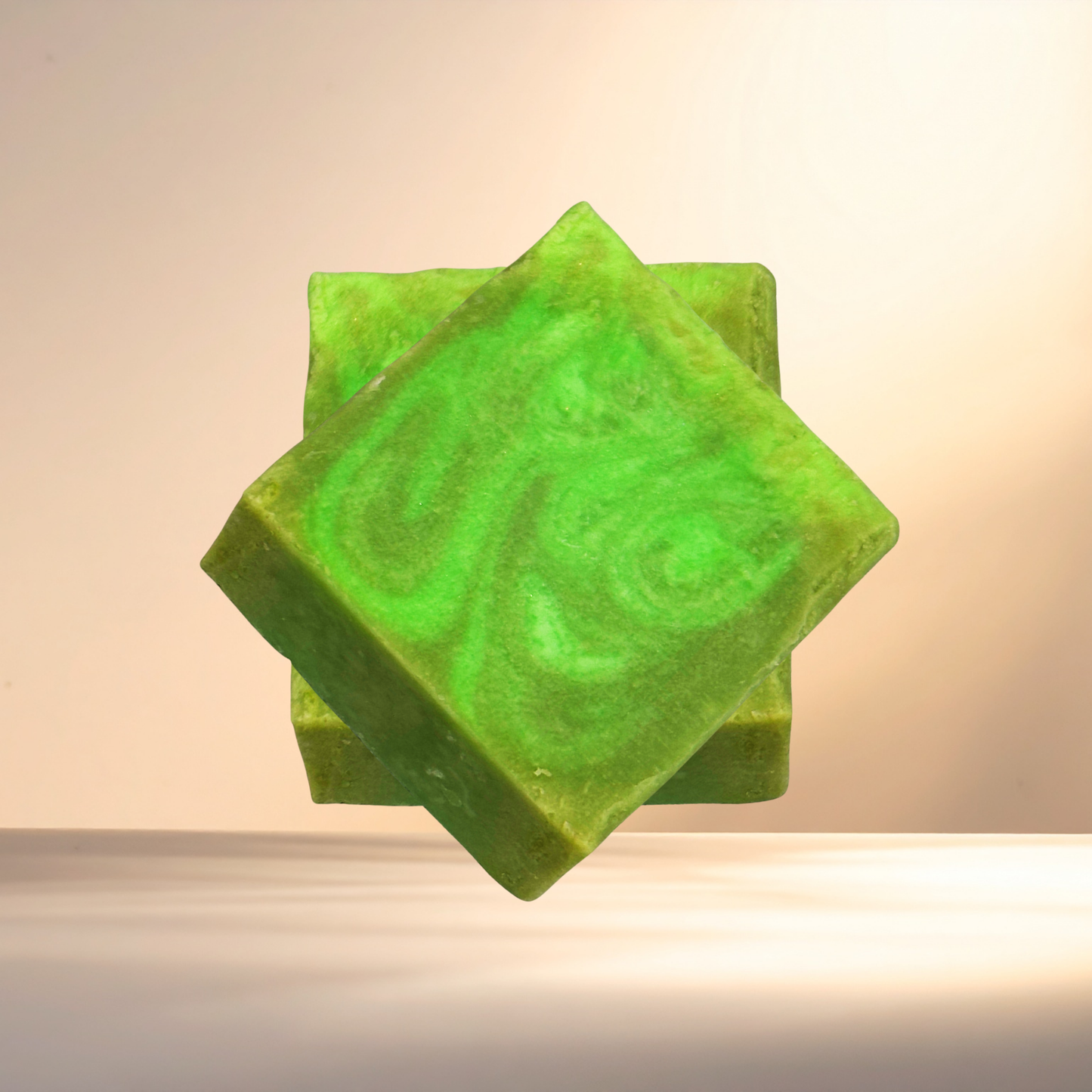 Green soap bar with a decorative design on a neutral background