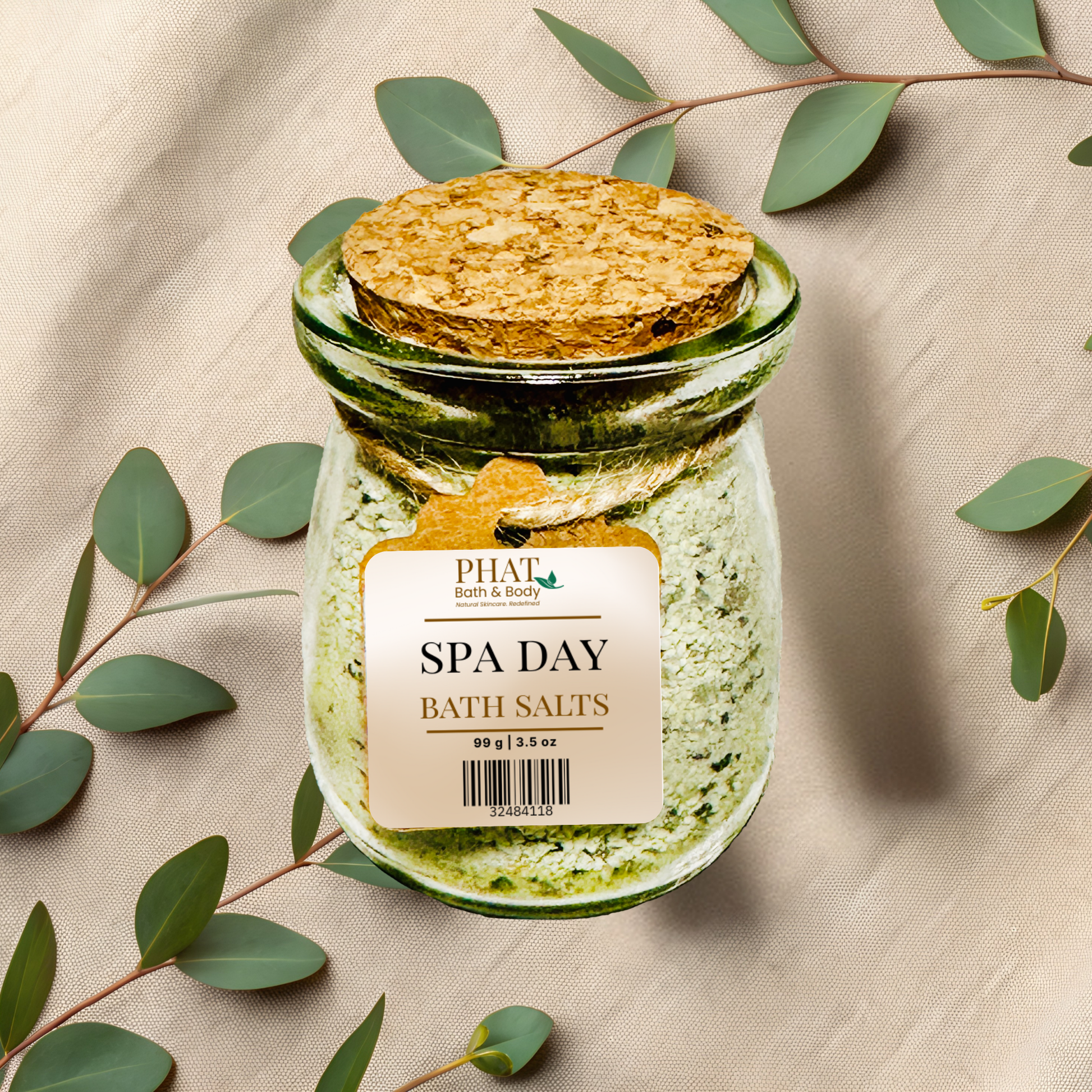 Jar of 'spa day' bath salts with a wooden scoop on a beige fabric background with eucalyptus leaves.