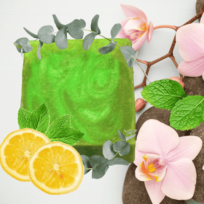 Green soap bar with lemon slices and flowers on a white background