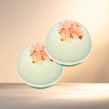 Two bath bombs with decorative elements on a gradient background