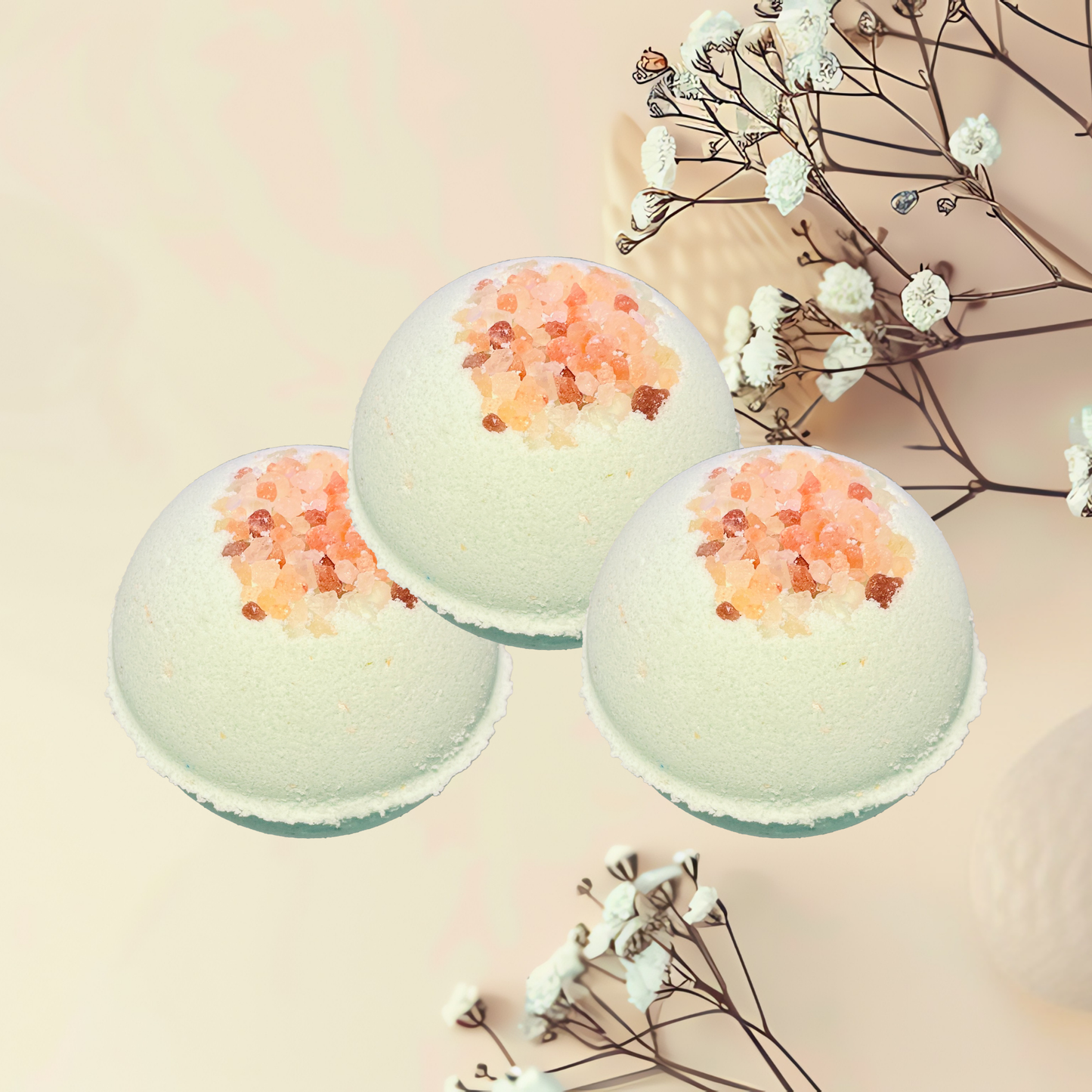 Three bath bombs with decorative elements on a light background
