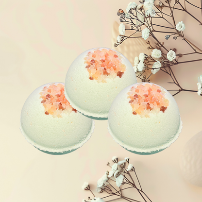 Three bath bombs with decorative elements on a light background