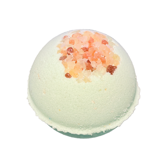 Green bath bomb with pink salt on a white background