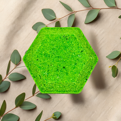 Hexagonal green steamer on a beige fabric background with green leaves
