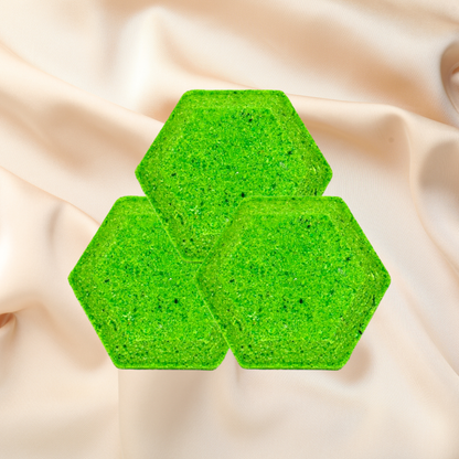 Three green hexagonal steamers on a beige fabric background