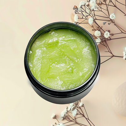 Green scrub in a black jar with white flowers on a beige background