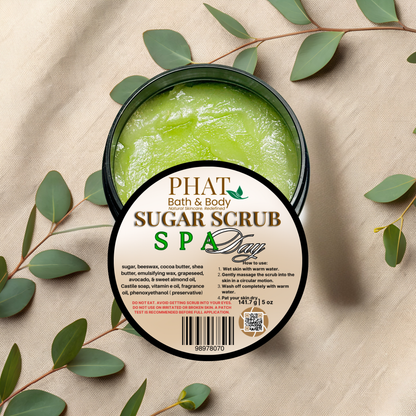 Green sugar scrub in a container with a label on a beige fabric background with green leaves.