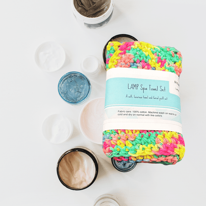 Colorful spa towel set with packaging on a white background