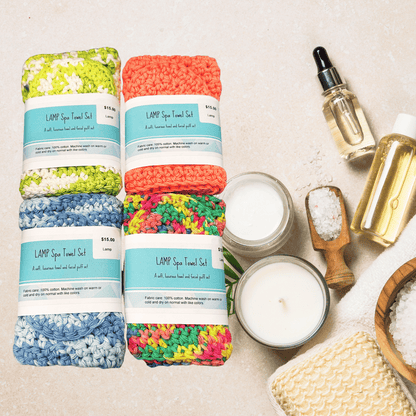 Colorful towel sets with spa items on a neutral background