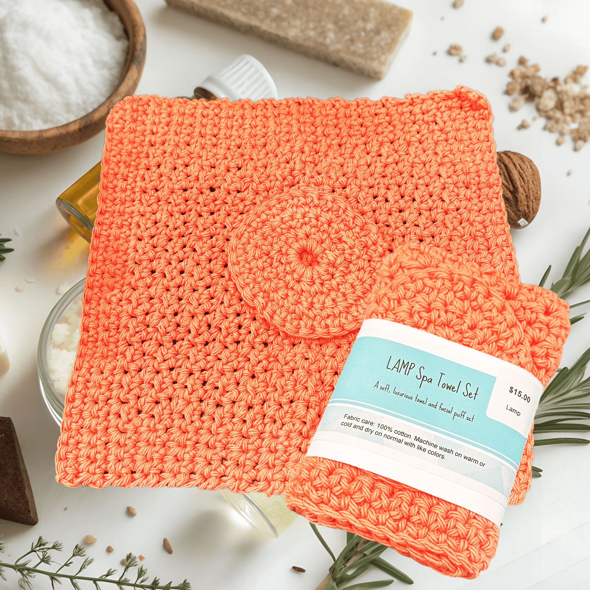 Coral-colored spa towel set with a label on a white background with spa items.