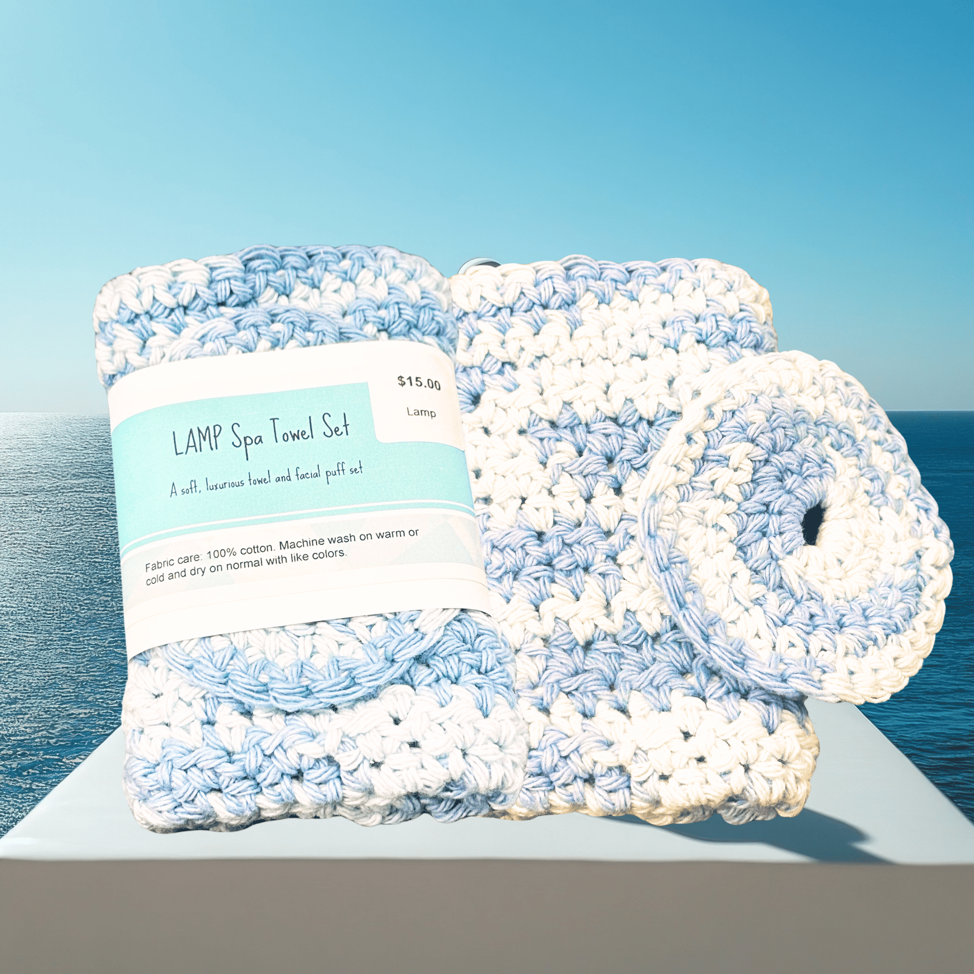 Set of blue and white crocheted bath towels with a label on a blue background