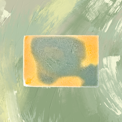 Rectangular bar of soap with green and yellow coloration on a textured green background