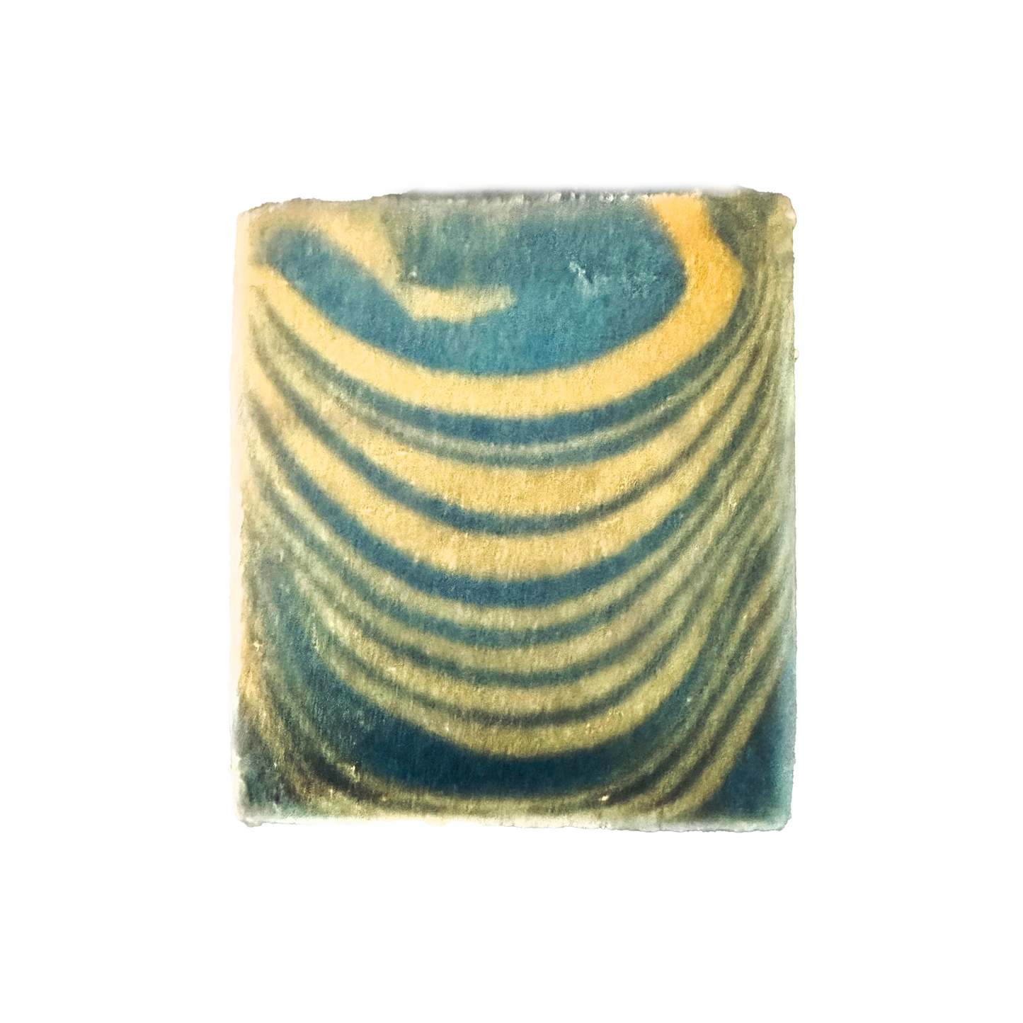 Marbled square soap with green and yellow patterns on a white background