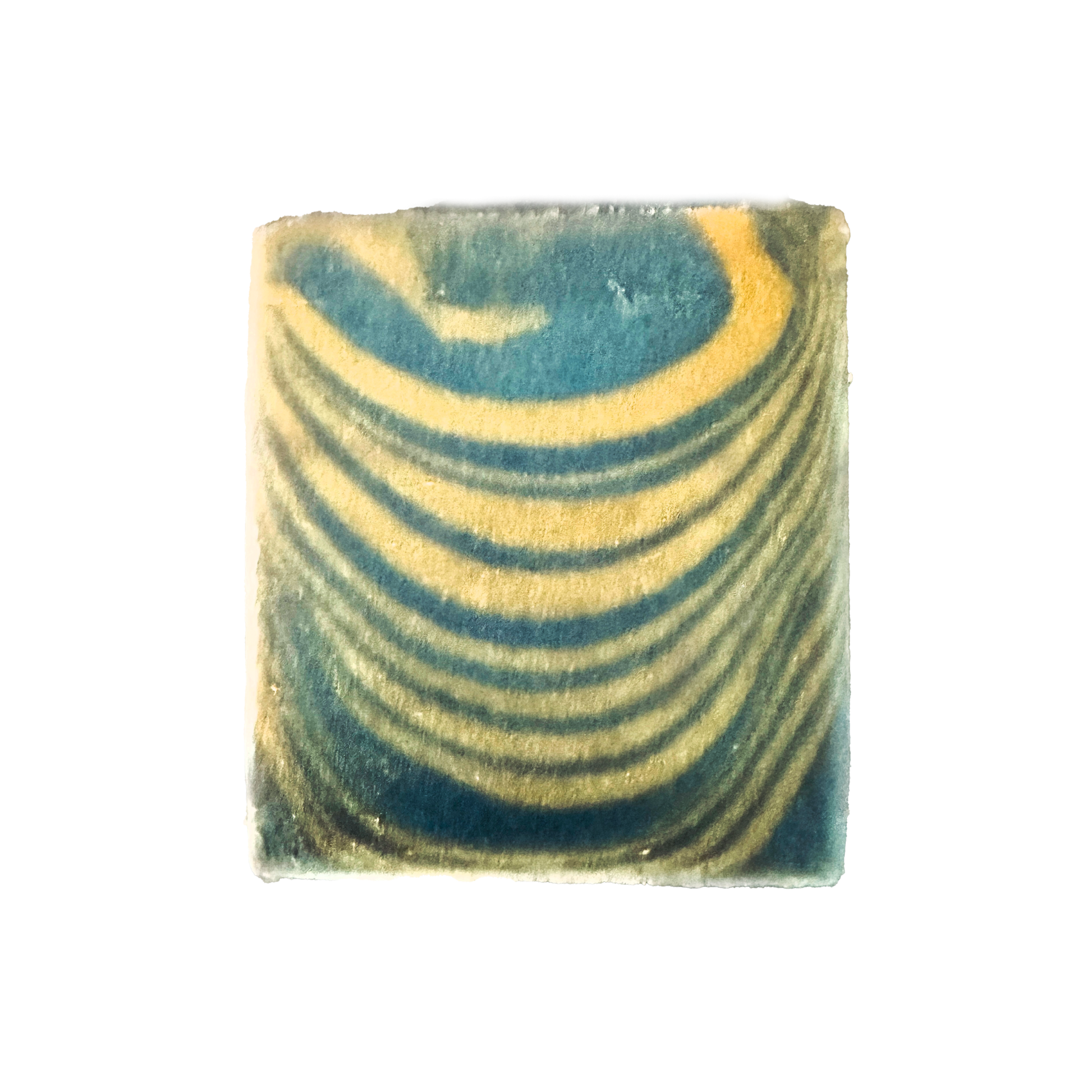 Marbled square soap with green and yellow patterns on a white background
