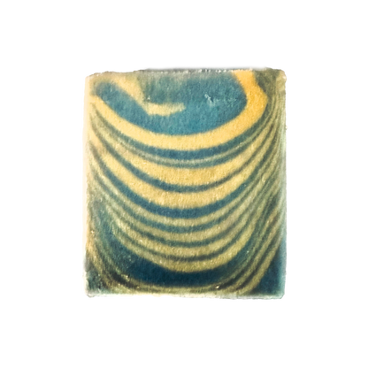 Marbled square soap with green and yellow patterns on a white background