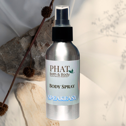 Body spray bottle labeled 'PHAT Bath & Body' on a natural stone background