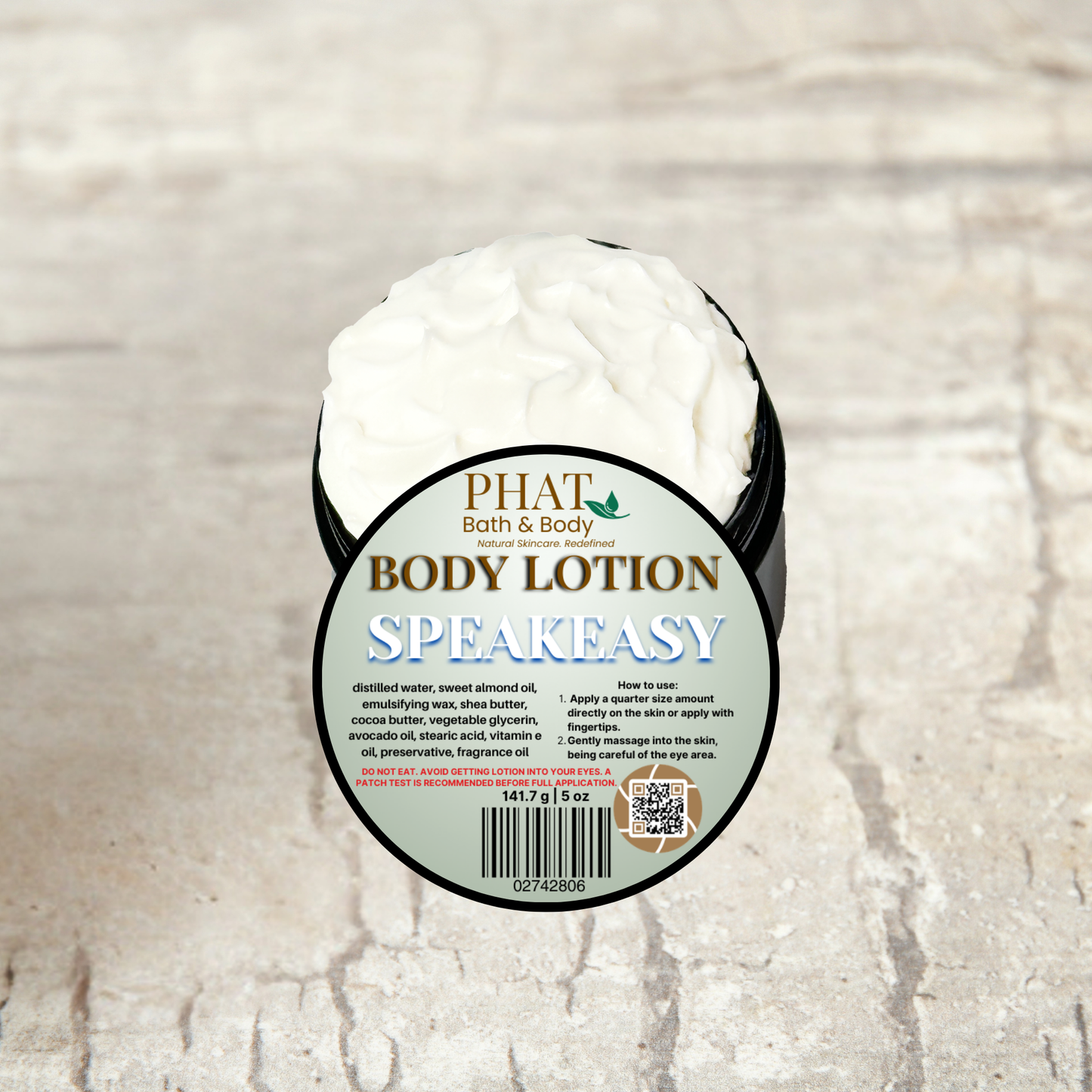 Body lotion container labeled 'Speakeasy' by 'Phat Bath & Body' on a textured beige background