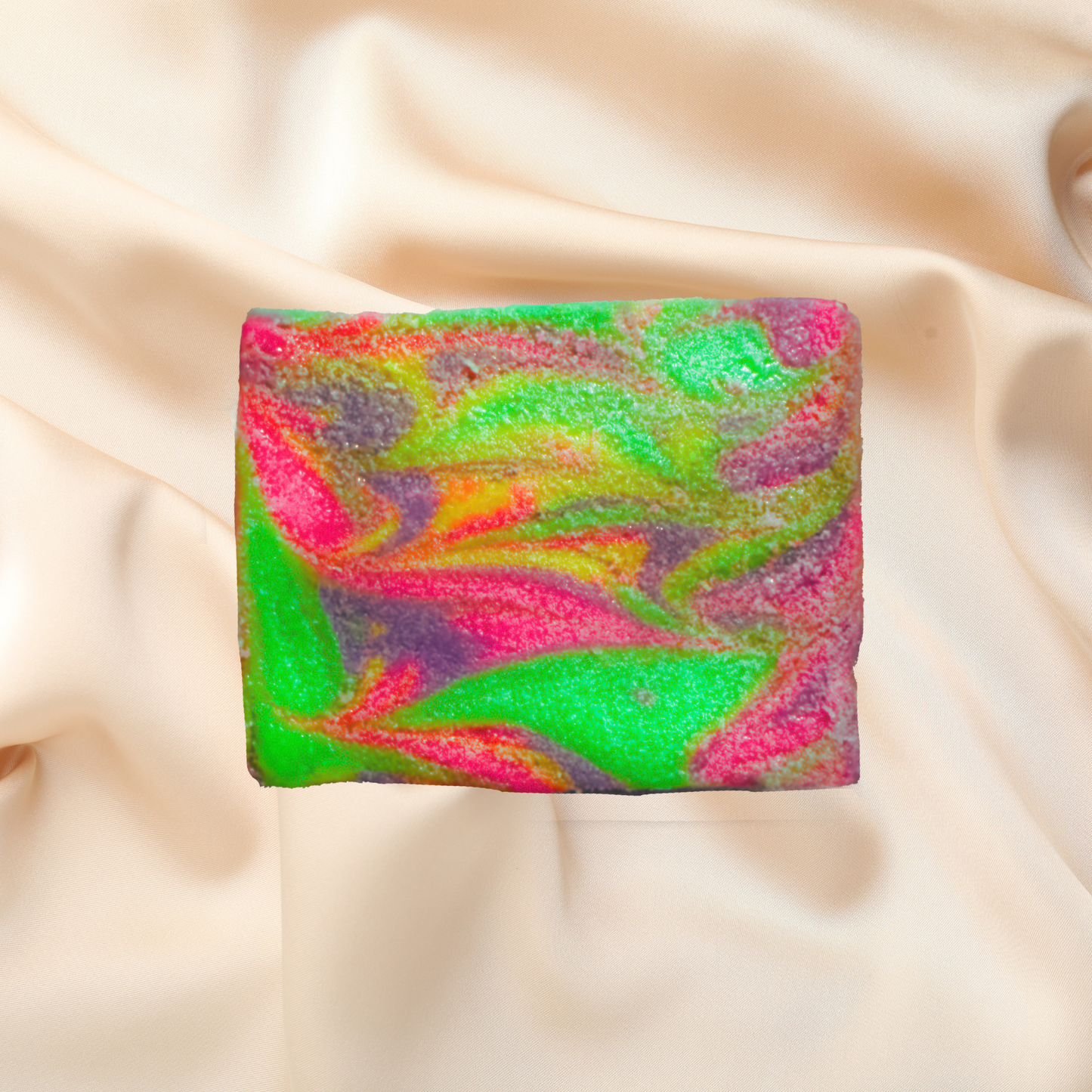 Colorful soap bar with a rainbow pattern on a beige fabric background