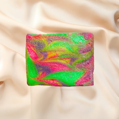 Colorful soap bar with a rainbow pattern on a beige fabric background