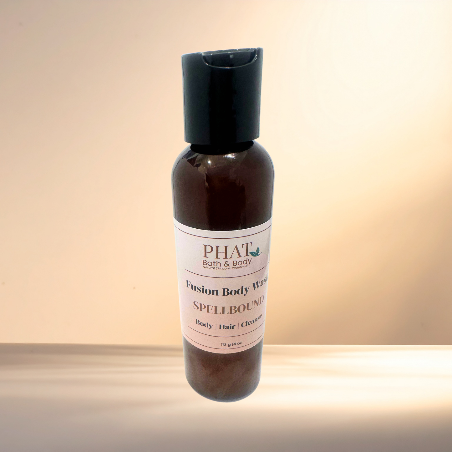 Bottle of PHAT Bath & Body Spellbound Fusion Body Wash on a gradient background
