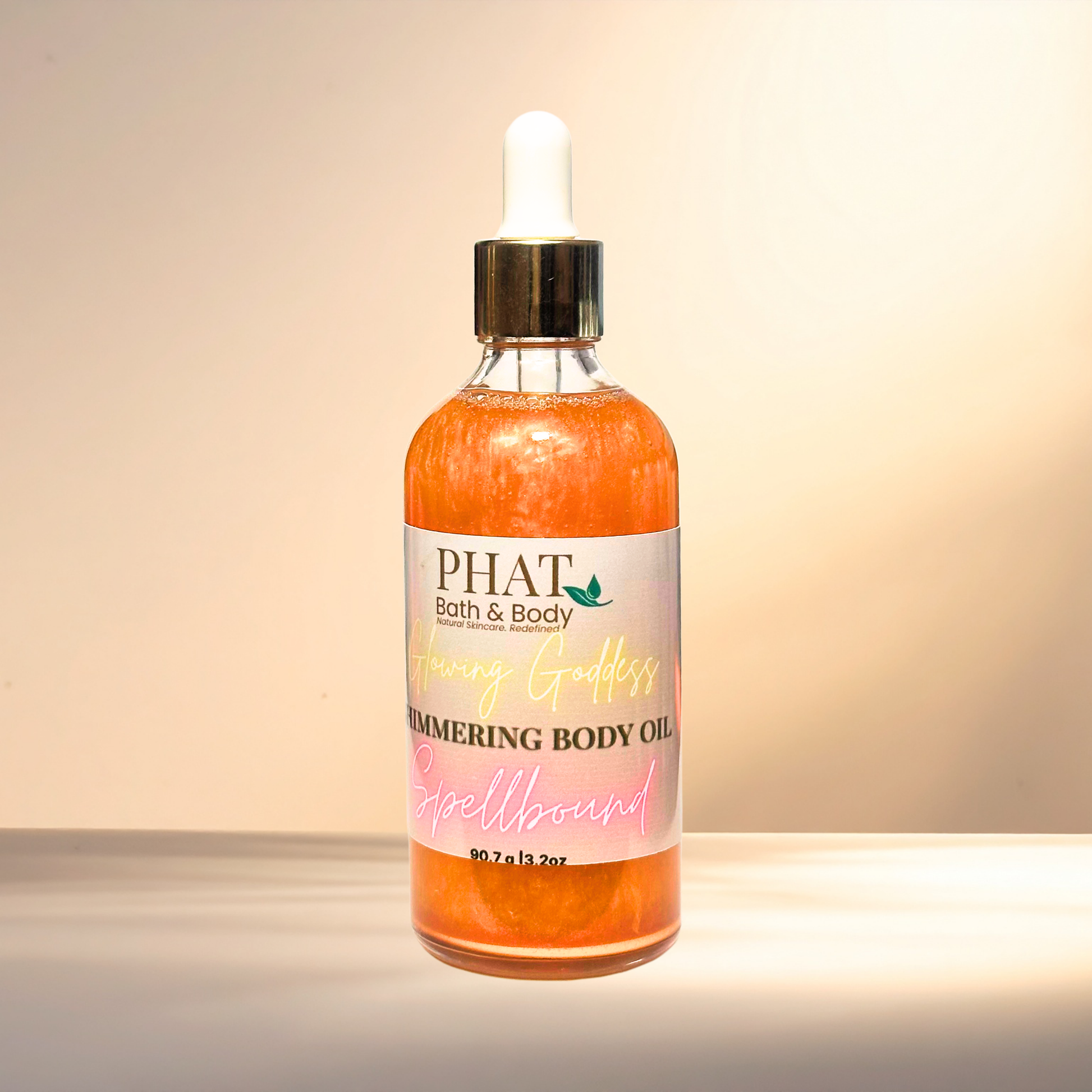 Bottle of PHAT Bath & Body shimmering body oil on a gradient background