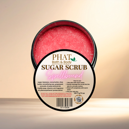 Pink sugar scrub in a container with 'PHAT Bath & Body' branding on a beige background