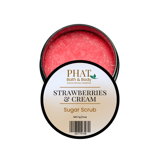 An open round tin of PHAT Bath & Body Strawberry & Cream Sugar Scrub, showing the pinkish-red scrub inside, with the white and gold label facing forward on a plain white background.
