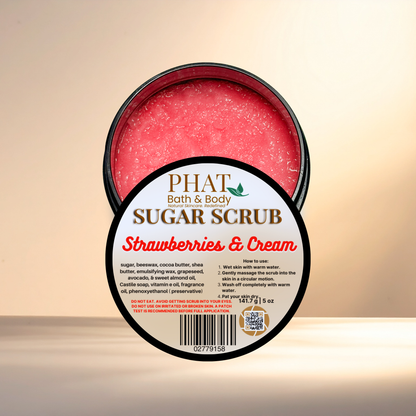Jar of sugar scrub labeled 'Strawberries & Cream' from Phat Bath & Body on a beige background
