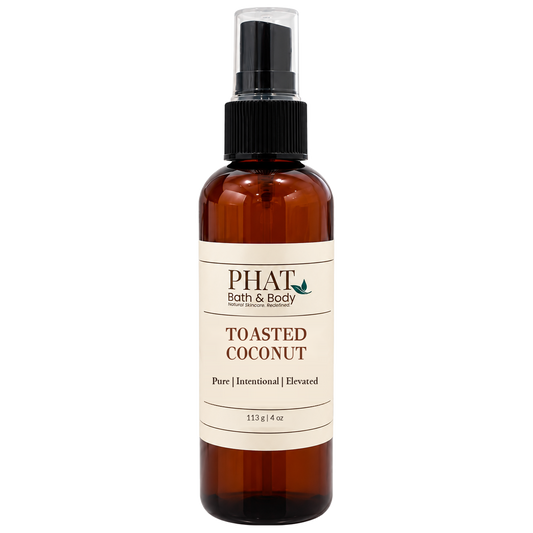 Phat Bath & Body Toasted Coconut Body Spray in a 4 oz amber bottle. A warm, tropical gourmand fragrance mist featuring creamy coconut, toasted sugar, and cozy sweetness.