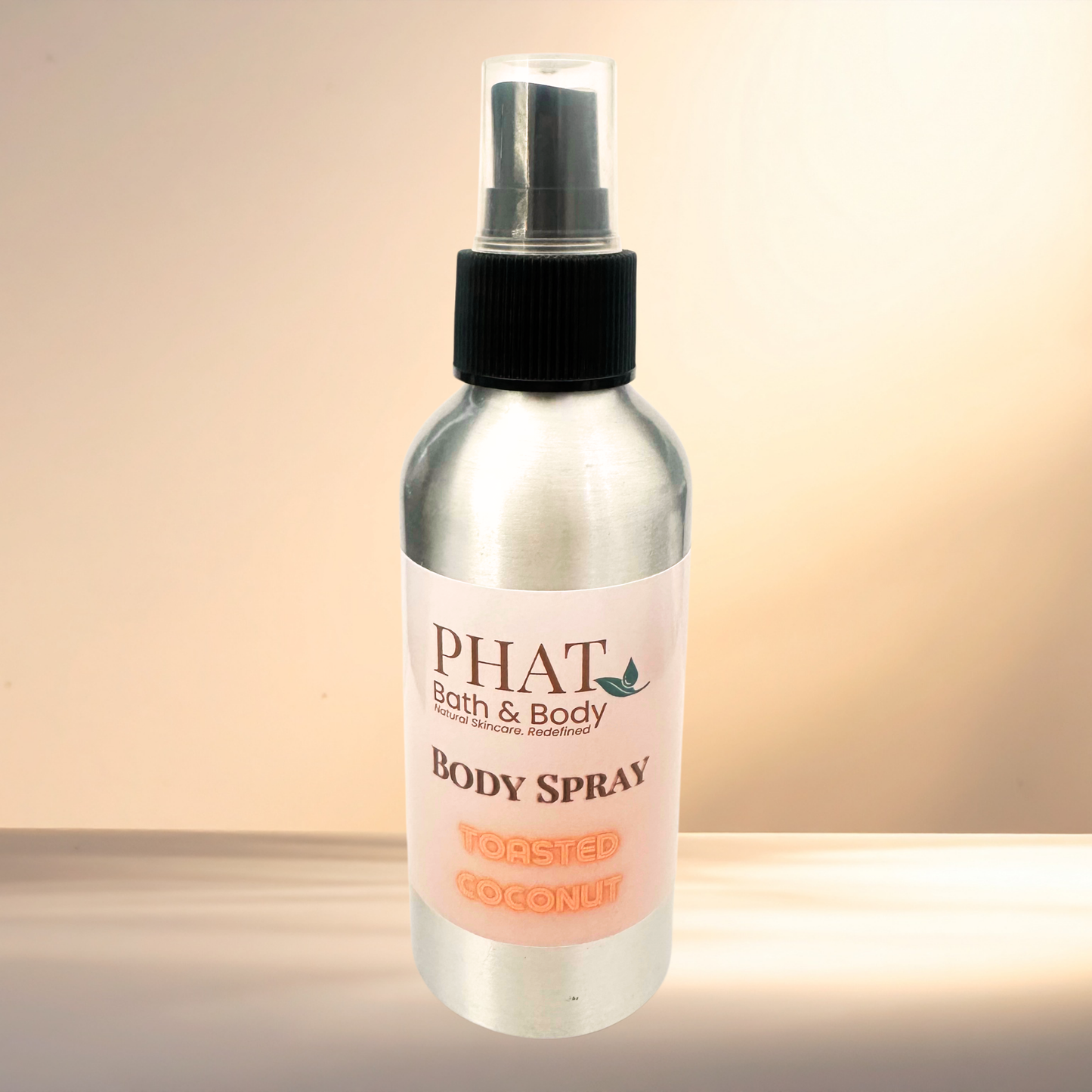 Body spray bottle labeled 'PHAT Bath & Body' on a gradient background