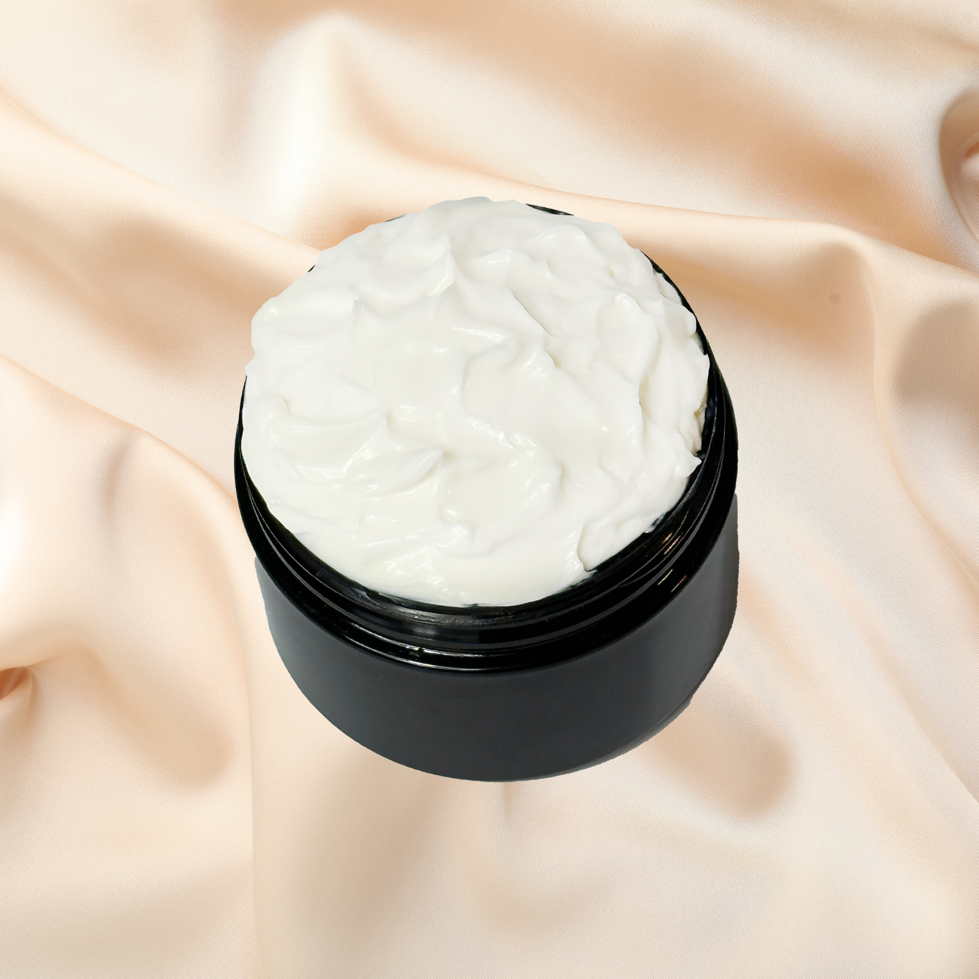 Black jar of cream on a beige fabric background