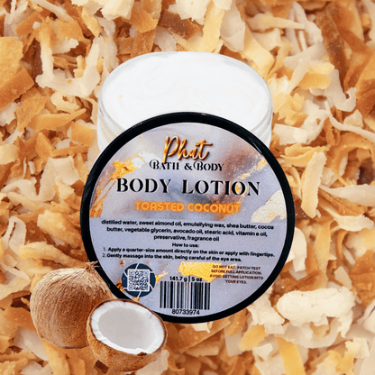 Body lotion container labeled 'Toasted Coconut' on a background of coconut shreds and pieces.