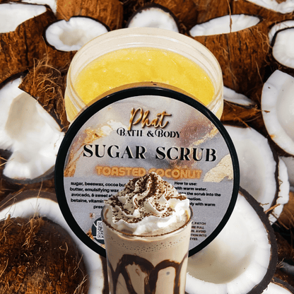 Jar of Phat Bath & Body Toasted Coconut Sugar Scrub surrounded by coconut halves.