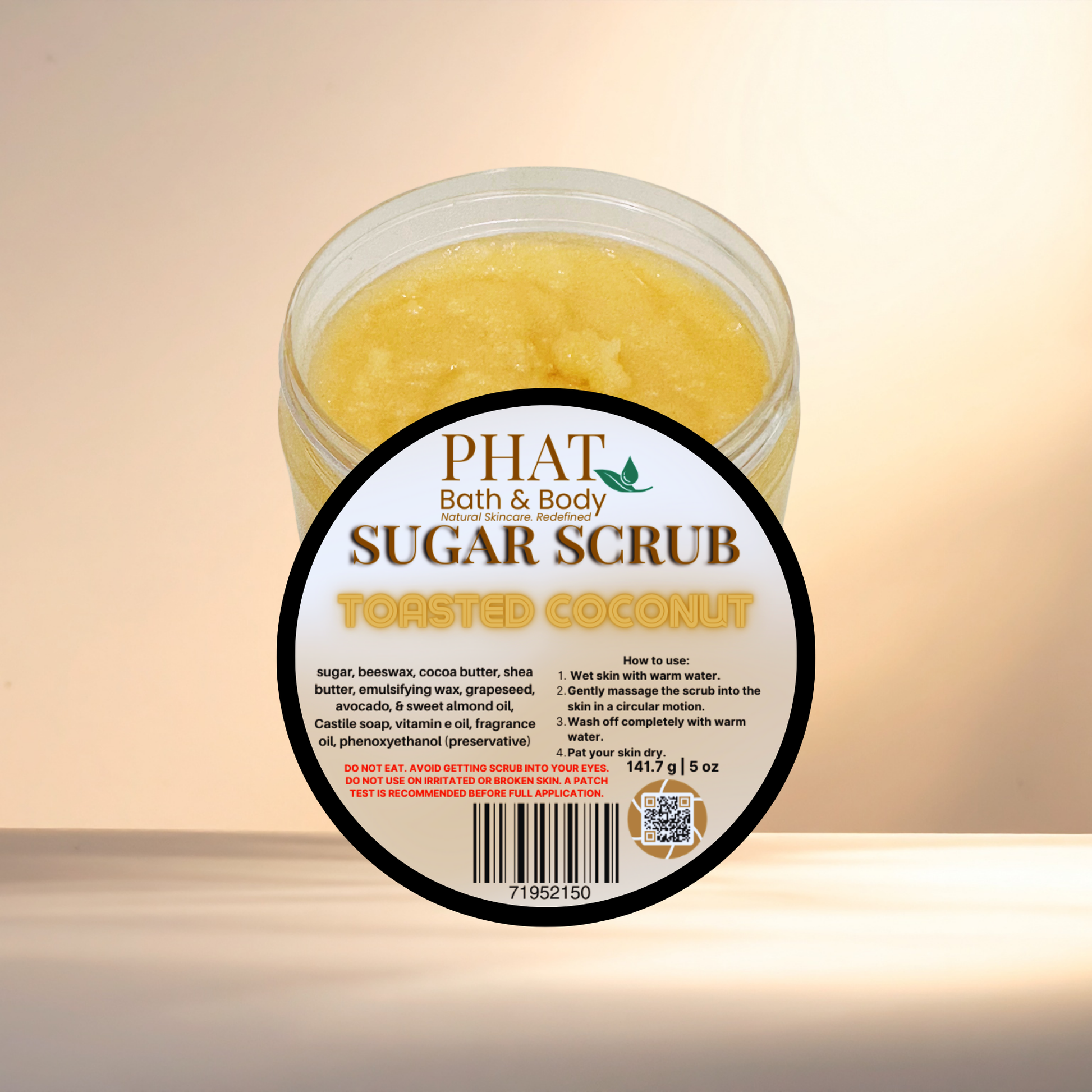 Jar of Phat Bath & Body Toasted Coconut Sugar Scrub on a beige background