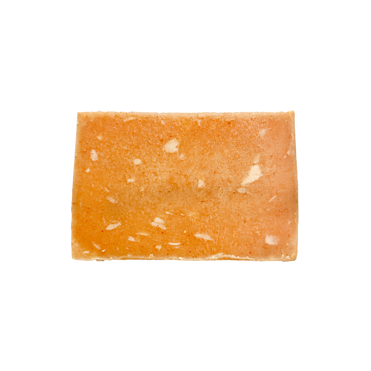 Rectangular piece of orange-colored soap with white specks on a white background
