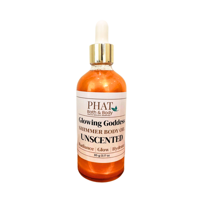A bottle of PHAT Bath & Body 'Glowing Goddess' shimmer body oil, unscented, in an glass bottle with a white label and a gold-and-white dropper cap, isolated on a white background.