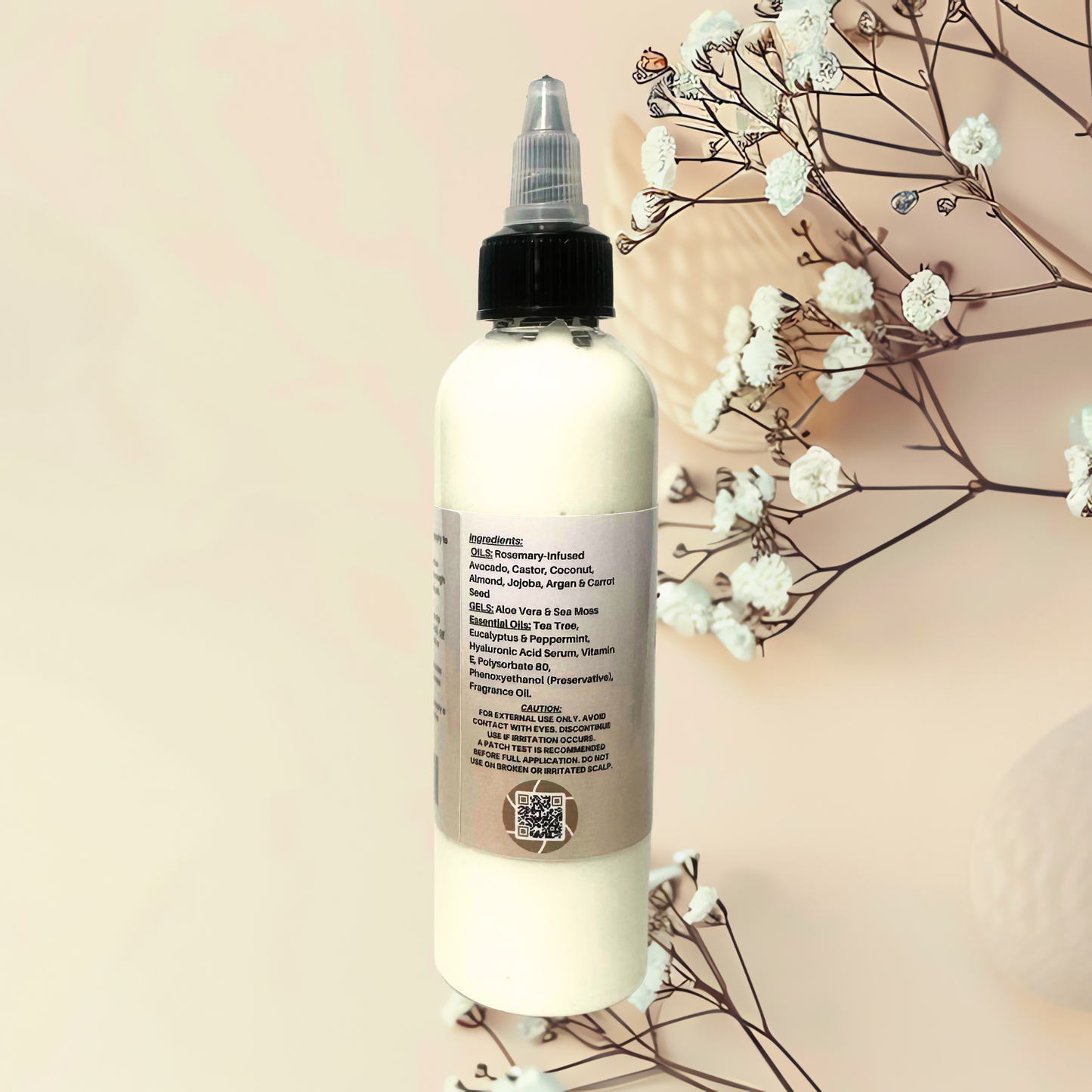 Bottle of hair care product with a floral arrangement on a soft pink background