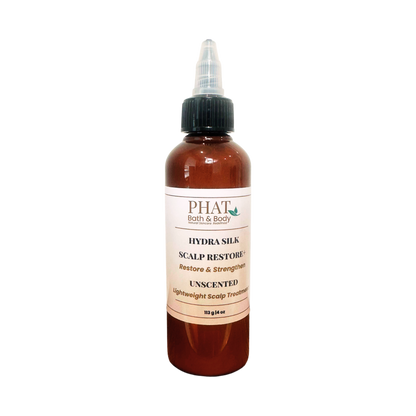 An amber bottle of PHAT Bath & Body Hydra Silk Scalp Restore Unscented scalp treatment with a black dropper cap and a beige label, shown on a plain white background.