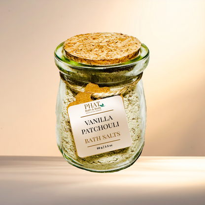 Jar of Vanilla Patchouli bath salts with a cork lid on a gradient background