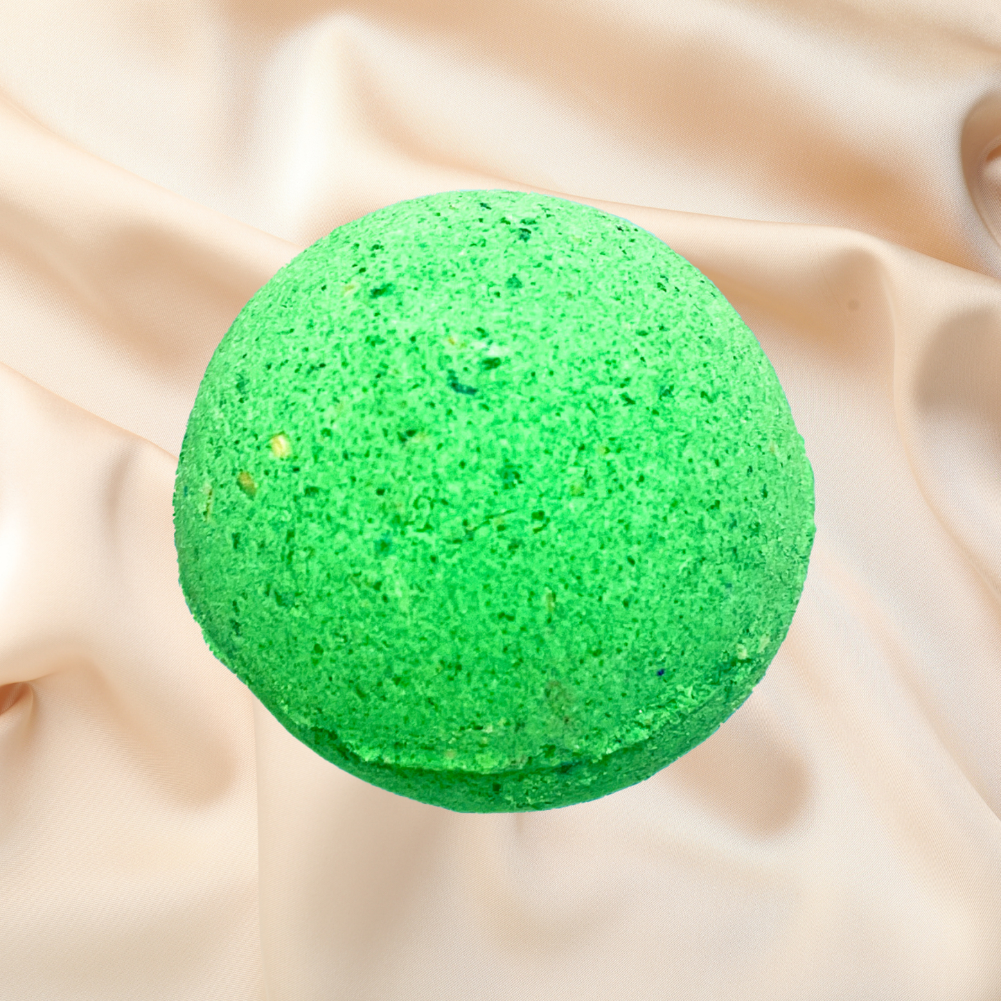 Green bath bomb on beige fabric