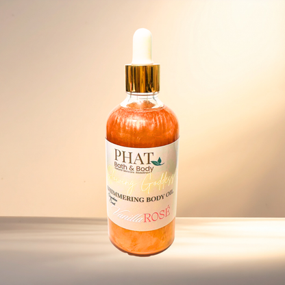 Bottle of 'PHAT Bath & Body' shimmering body oil with a gold dropper on a gradient background