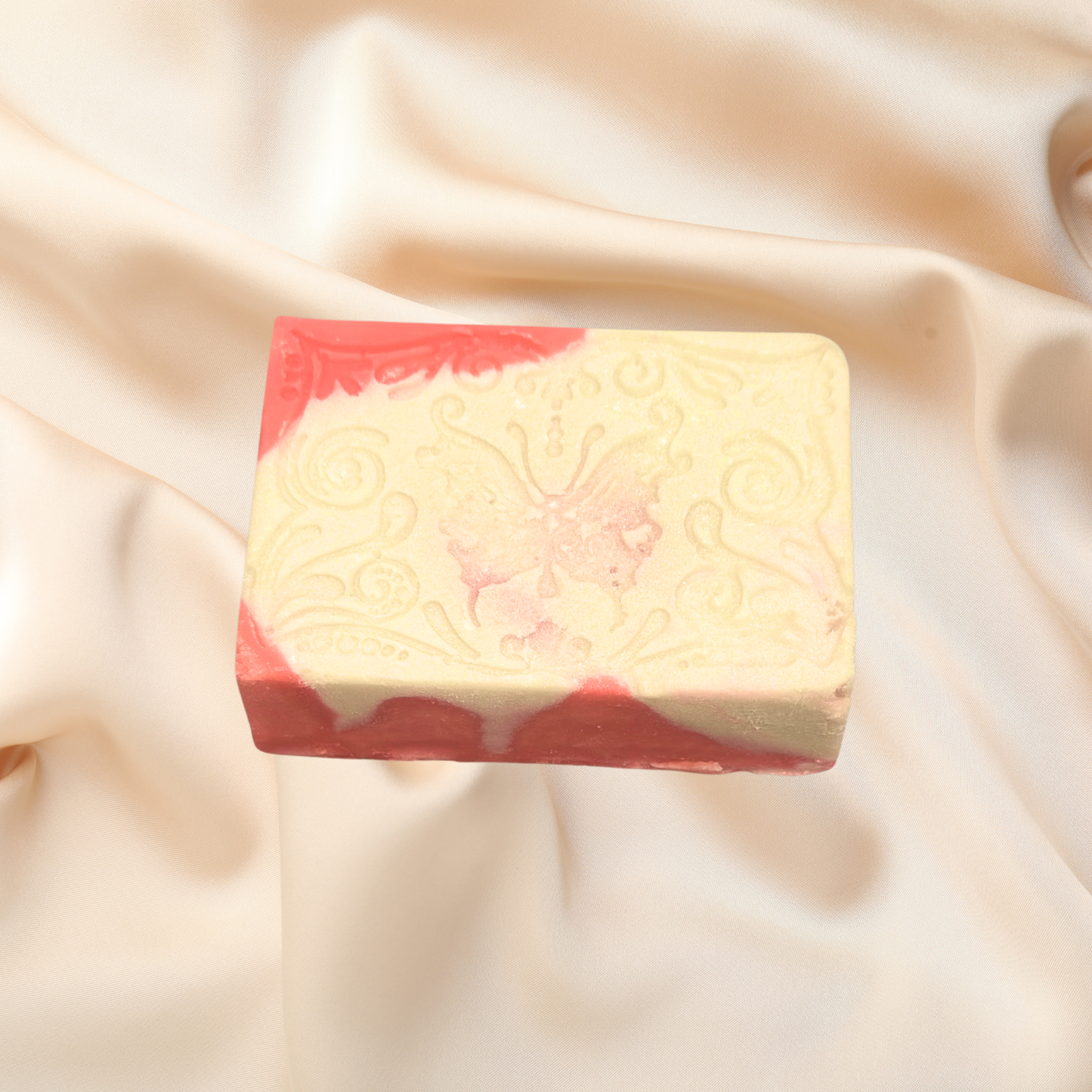 Bar of soap with red border on beige fabric