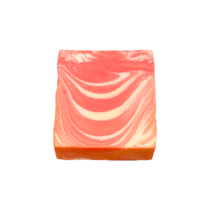 Swirled pink and orange soap bar on a white background