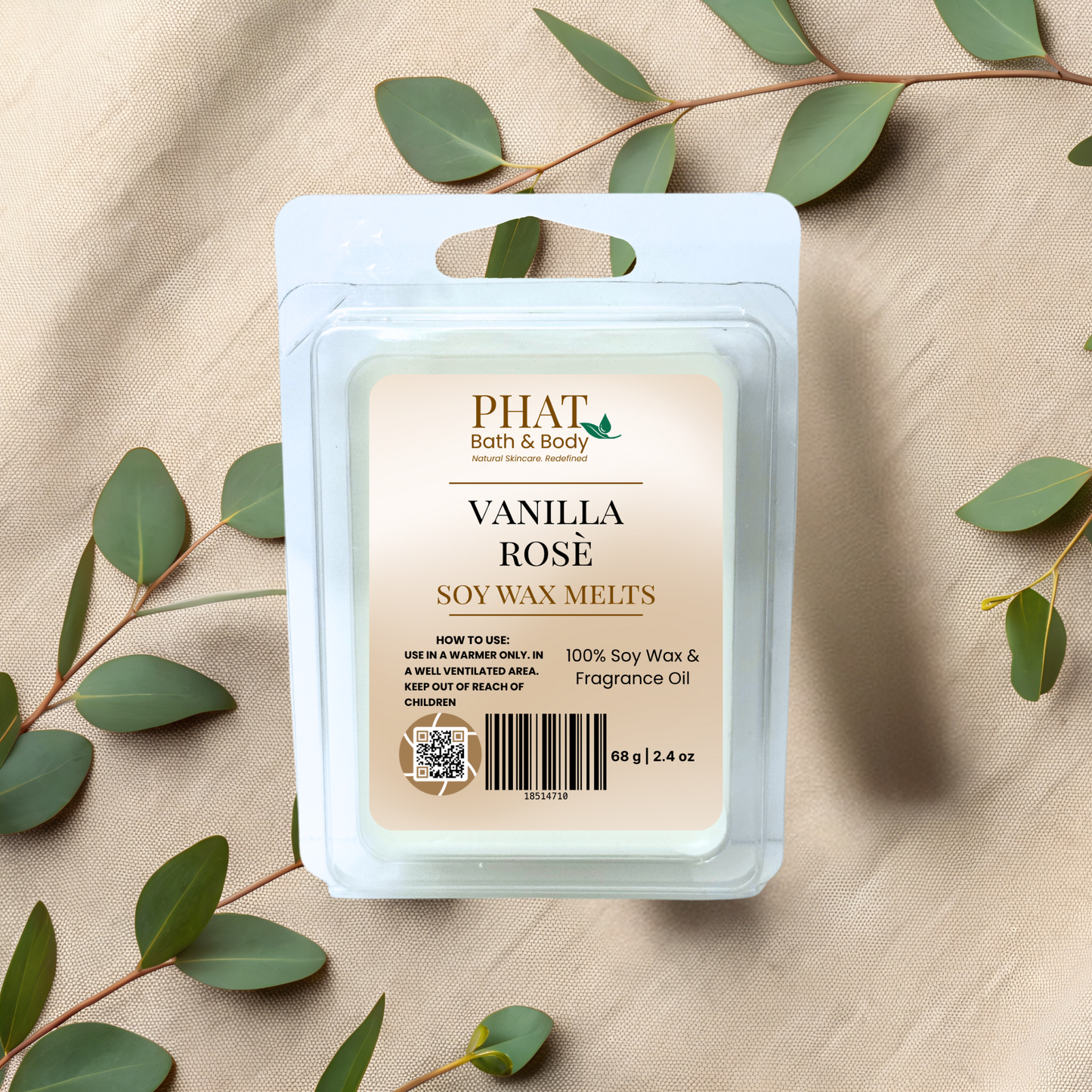 PHAT Bath & Body Vanilla Rosè Soy Wax Melts packaging with green leaves on a beige fabric background