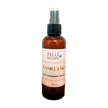 An amber spray bottle of PHAT Bath & Body Vanilla Sky, featuring a black spray nozzle and a cream-colored label with brown text.