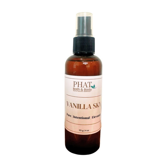 An amber spray bottle of PHAT Bath & Body Vanilla Sky, featuring a black spray nozzle and a cream-colored label with brown text.